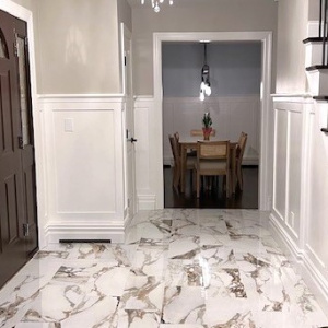 Elegant Foyer Transformation Featuring Polished Porcelain